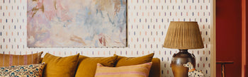 Cole & Son Inlay wallpaper with a velvet sofa