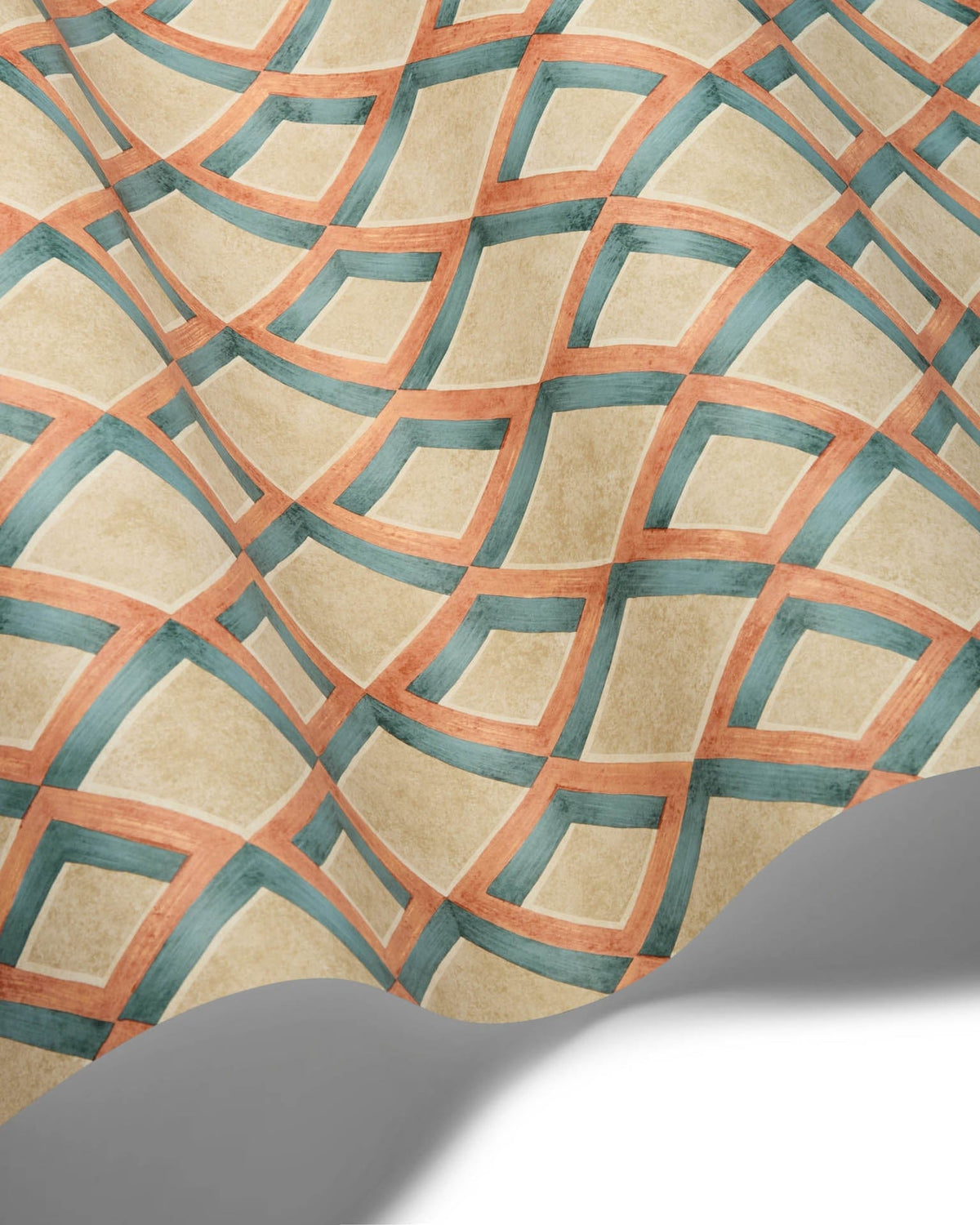 A close-up of a patterned surface with a beige base and a repeating geometric lattice design in teal and terracotta, with a curled lower edge casting a shadow against a white background.